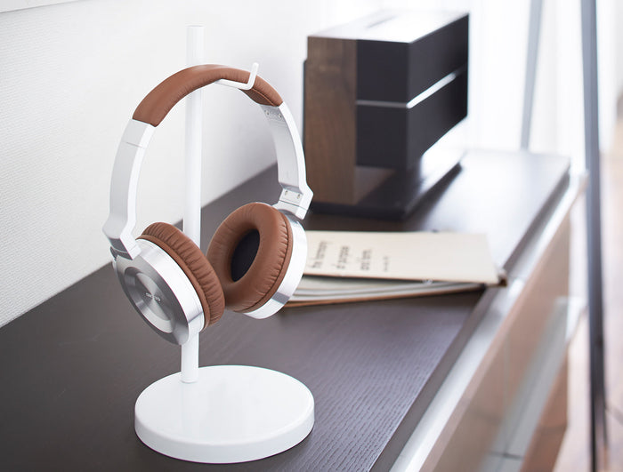 Yamazaki Home white headphone stand on a modern desk. 