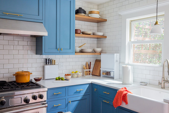 Modern kitchen with blue counters featuring a Concealable Spice Rack from Yamazaki Home