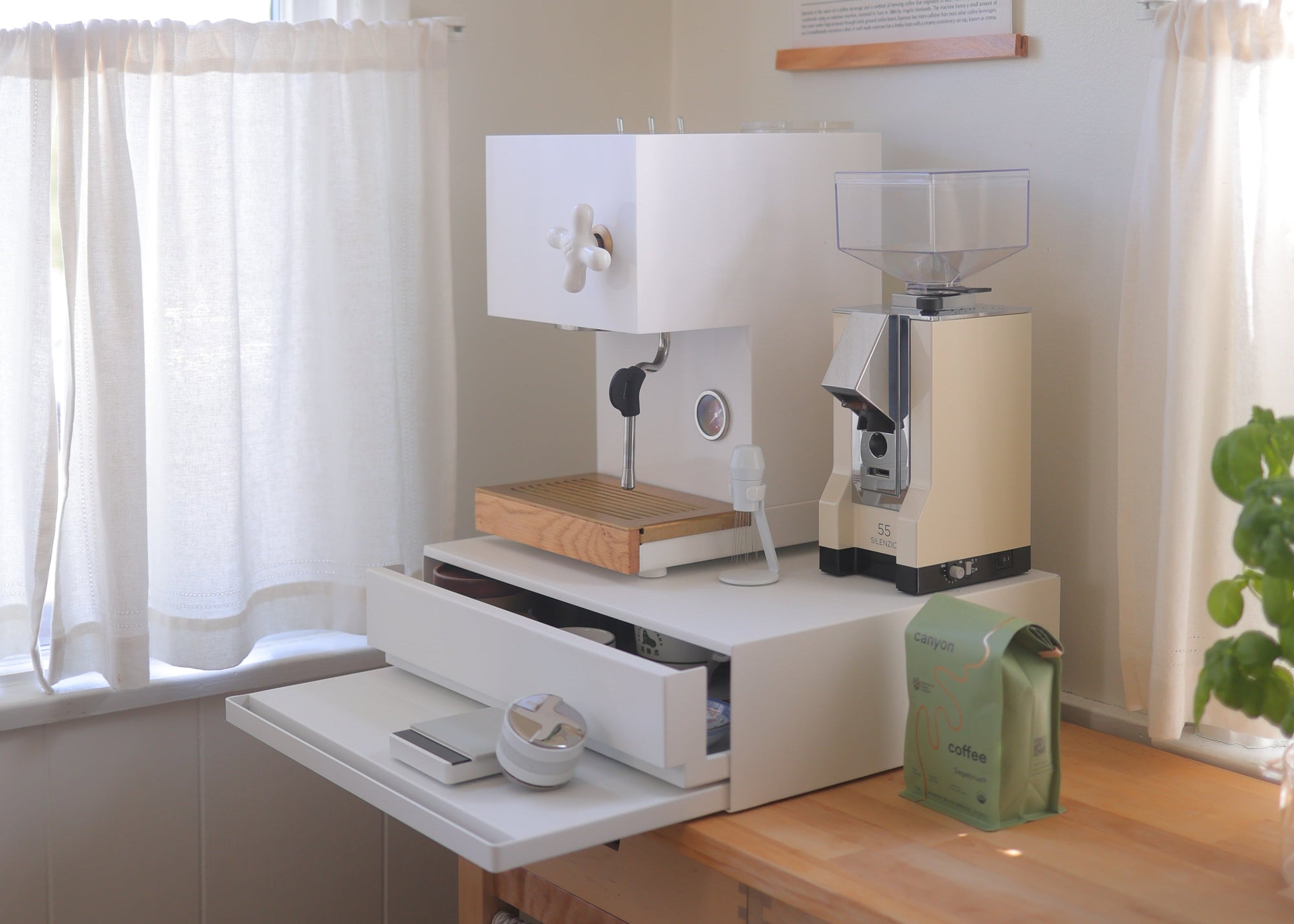 Coffee corner designed by Wah Wu featuring white countertop drawer from yamazaki home with a retro espresso machine and juicer on top. Cottage-core cozy kitchen. Minimalist. Danish