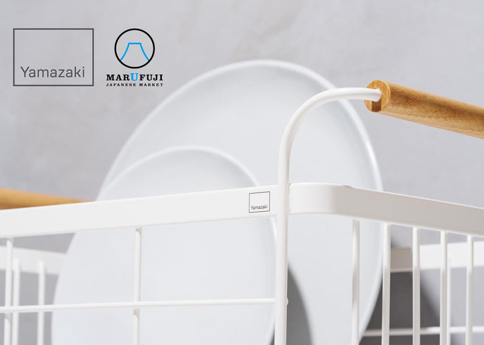 Dish rack in white steel with wood handles holding two dishes. Yamazaki Home logo and Marufuji Japanese Market logos in top right corner.