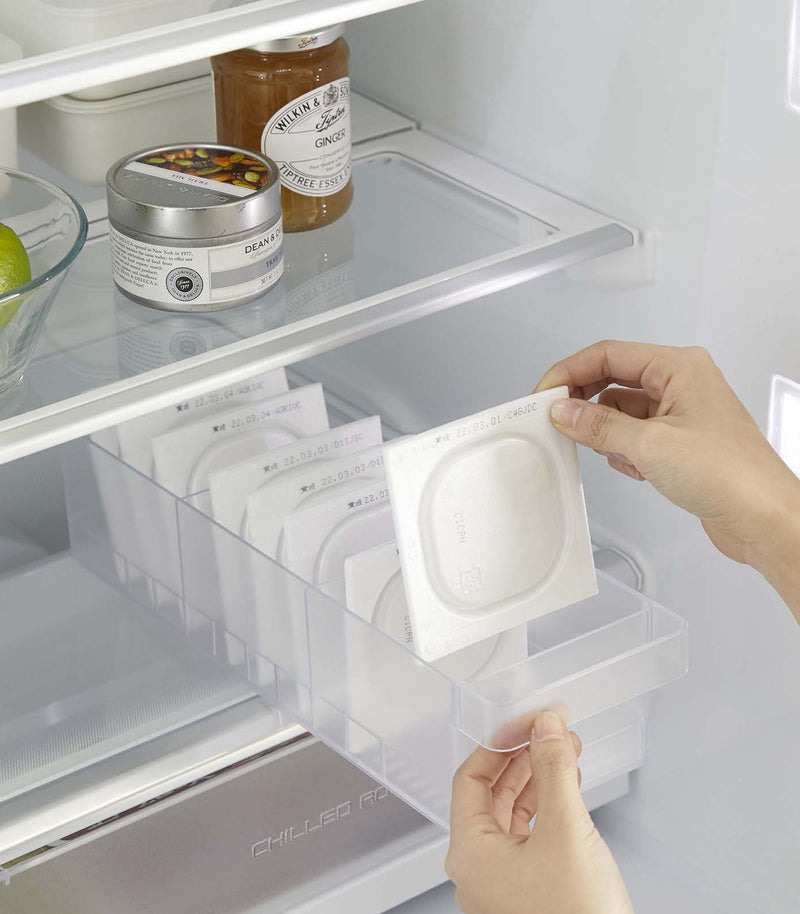 Yamazaki Refridgerator Organizer Bins being pulled out of shelf in refridgerator full of food