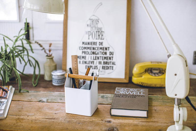 Front view of white Pen Organizer holding pens and pencils by Yamazaki Home.