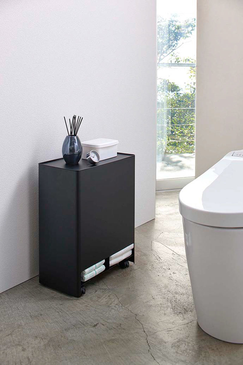 Black Rolling Diaper Stacker open holding diapers in bathroom by Yamazaki Home.