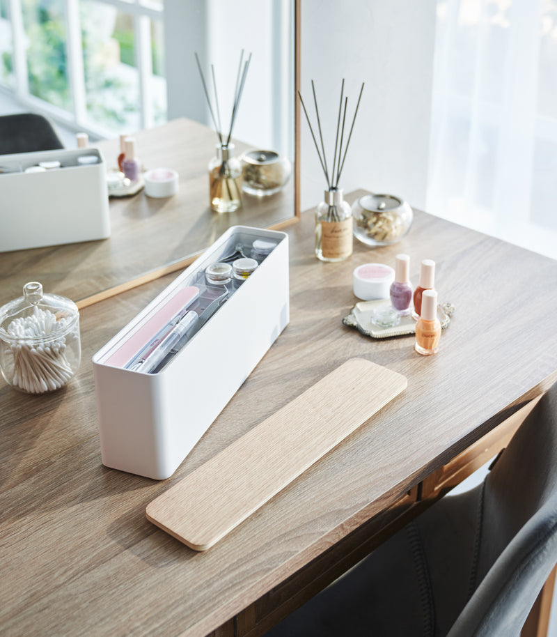 An open Yamazaki Nail Polish Organizer holding various nail accessories on a table.
