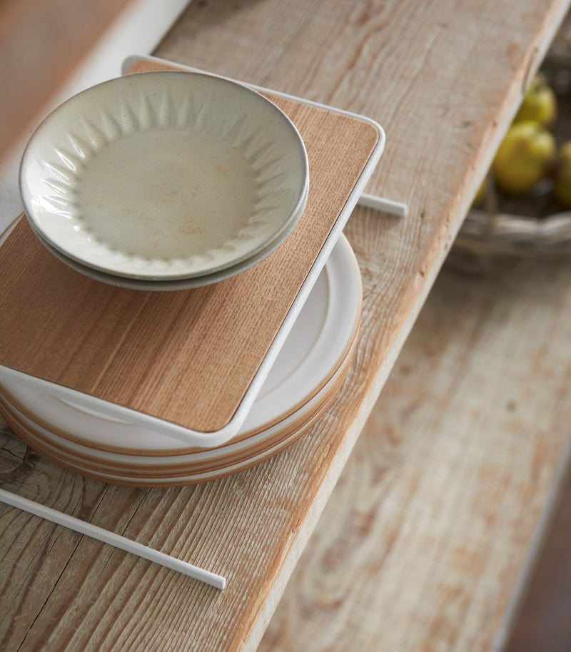 Aerial view of Dish Riser holding plates on shelf by Yamazaki Home.