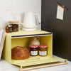 Yellow Pear Yamazaki Home Bread Box open with jam and bread inside on a kitchen counter
