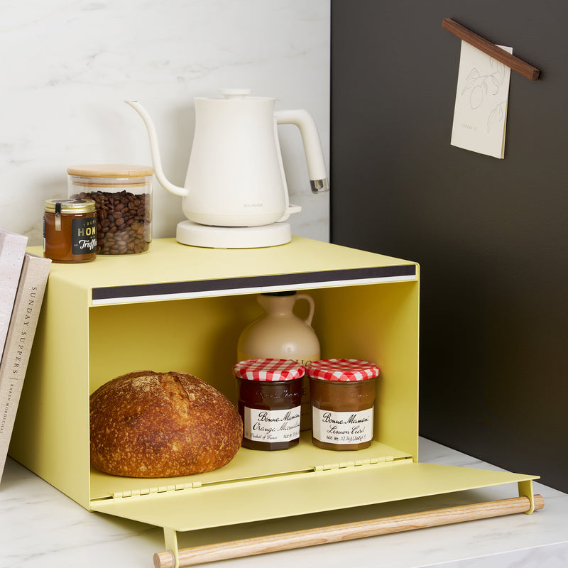 Yellow Pear Yamazaki Home Bread Box open with jam and bread inside on a kitchen counter