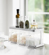 White Pantry Organizer with upper shelf holding spices and oils by Yamazaki Home.