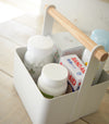 Close up aerial view of white Storage Caddy holding first aid items by Yamazaki Home.