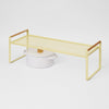 Yellow metal shelf with a white pot on a light gray background