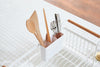 White Over-the-Sink Expandable Dish Drying Rack holding silverware by Yamazaki Home.