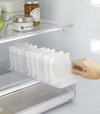 Yamazaki Refridgerator Organizer Bins being pulled out of shelf in refridgerator with food inside
