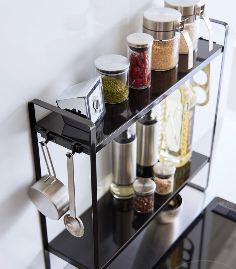 Aerial view of Yamazaki Home Two-Tier Countertop Rack holding spices and oils.