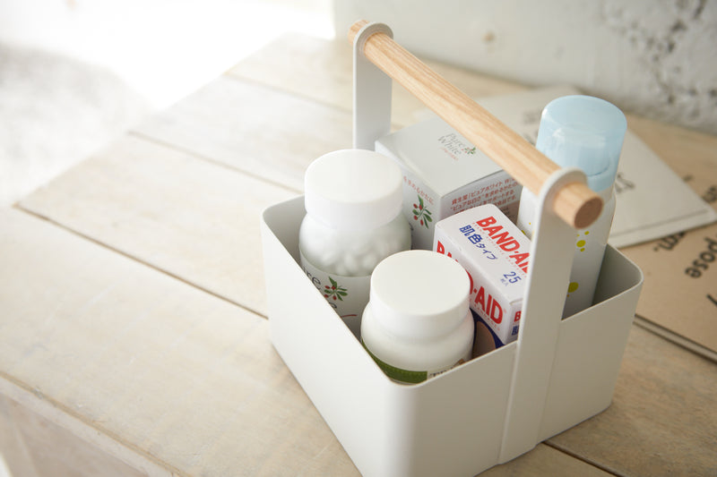 Aerial view of white Storage Caddy holding first-aid items by Yamazaki Home.