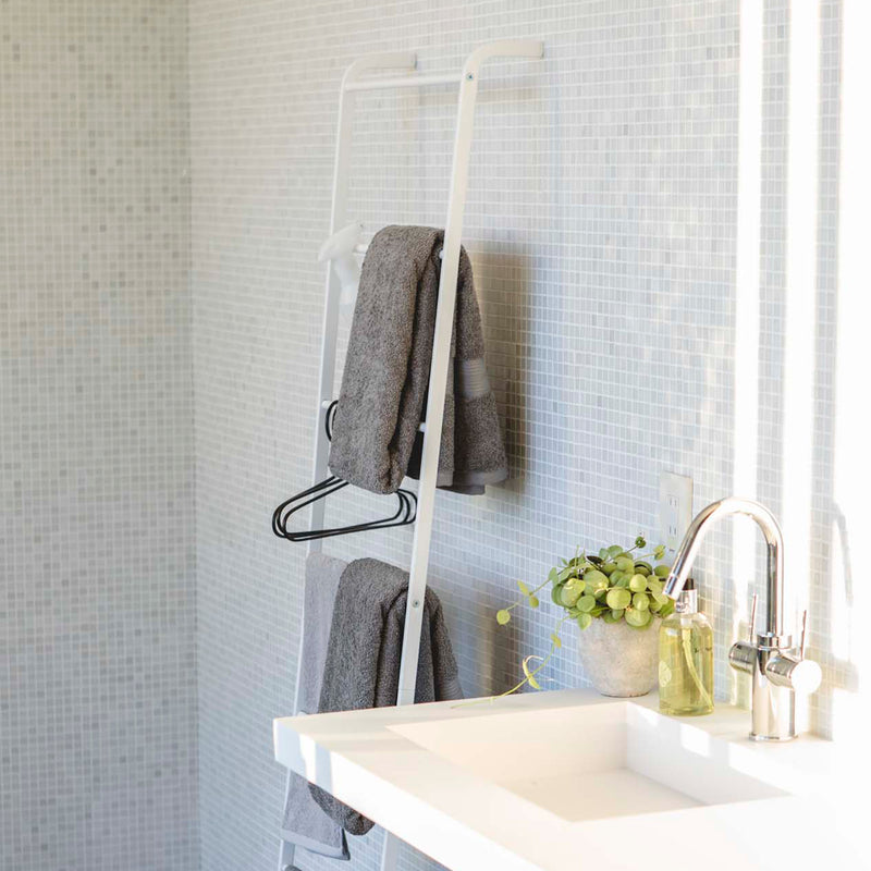 Side view of Leaning Ladder Hanger holding towels and bathroom essentials.