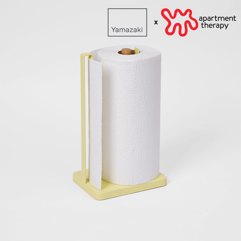Paper Towel Holder with props on the white background, having a logo on the upper right.