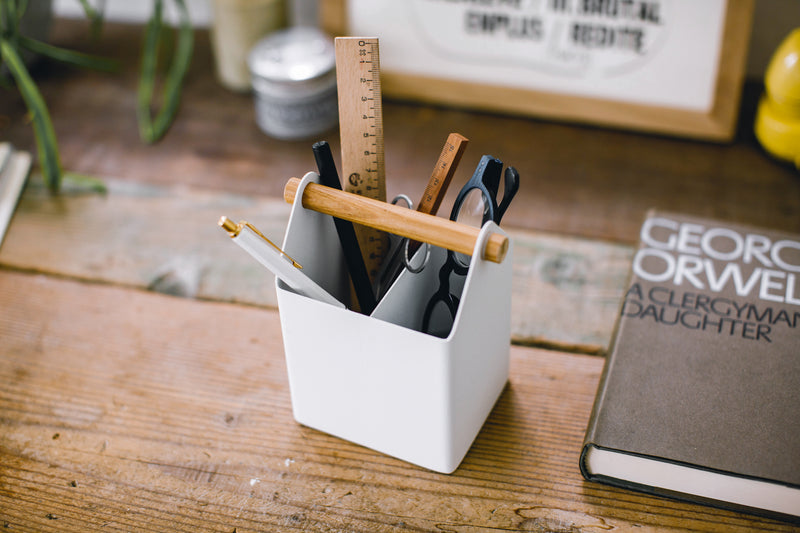 Aerial view of white Pencil Organizer holding glasses, pens, and ruler by Yamazaki Home.
