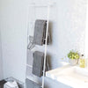 Side view of Leaning Ladder Hanger holding towels, hangers, and bathroom essentials.