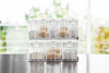 Front view of white Pantry Organizer with upper shelf storage by Yamazaki Home.
