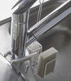 Rear of white Steel Yamazaki Home Faucet-Hanging Sponge & Brush Holder attached to a faucet