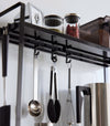 Hooks of Yamazaki Home Two-Tier Countertop Rack holding utensils.