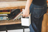 White Pen Organizer held by handle holding writing utensils by Yamazaki Home.