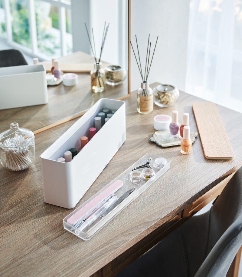 A Yamazaki Nail Polish Organizer with its tray removed sitting on a table.