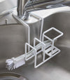White Steel Yamazaki Home Faucet-Hanging Sponge & Brush Holder holding a brush