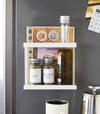 Front view of white Magnetic Wrap Holder on kitchen fridge by Yamazaki home.