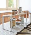 Black entryway Stackable Shoe Rack holding shoes by Yamazaki Home.