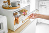 White Bread Box holding bread, spices, and jams on kitchen counter by Yamazaki Home.