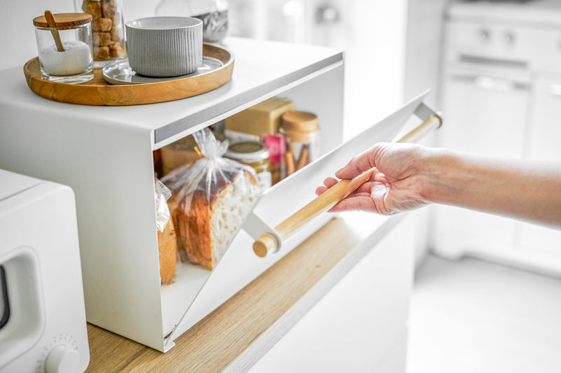 White Bread Box holding bread, spices, and jams on kitchen counter by Yamazaki Home.