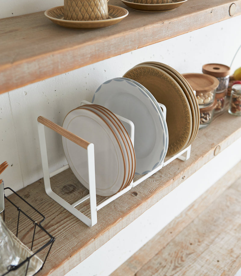 Wood-Accented Dish Storage Rack displaying plates on shelf by Yamazaki Home.