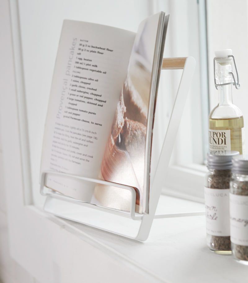 White Tablet and Cookbook Stand holding recipe book by Yamazaki home.