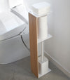 Toilet Paper Stocker holding wet wipes, toilet paper, and toilet brush in bathroom by Yamazaki Home.