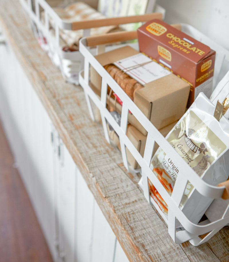 Close up aerial view of white Storage Basket holding food items by Yamazaki Home.