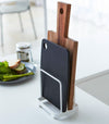 White Cutting Board Stand displaying cutting boards on countertop by Yamazaki Home.