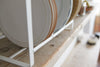 Close up bottom view of Wood-Accented Dish Storage Rack holding plates on shelf by Yamazaki Home.