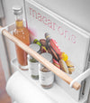 Aerieal view of white Magnetic Organizer holding oils, spices, and cookbook by Yamazaki Home.