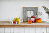 Front view of white Fruit Bowl holding fruit on shelf by Yamazaki Home.