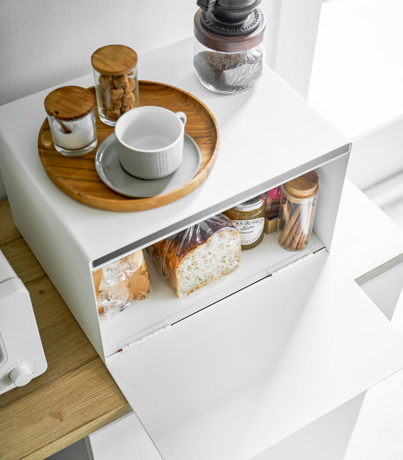 Aerial view of white Bread Box holding food items on kitchen shelf by Yamazaki Home.