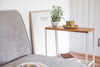 End Table holding cup, plant, and books in living room by Yamazaki Home.