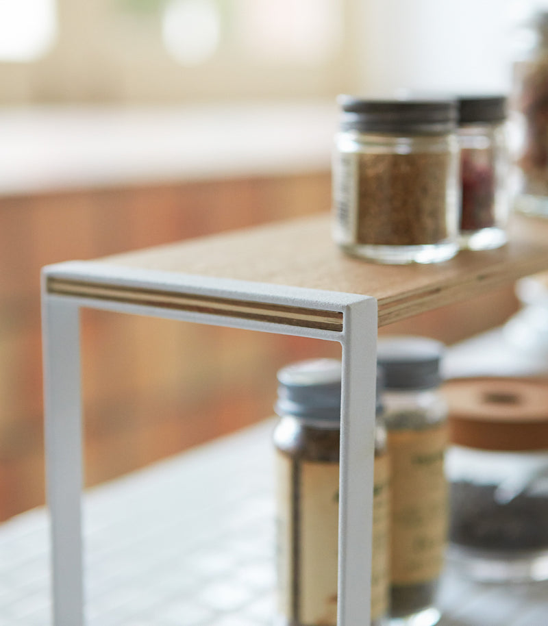 Side view of white Shoe Organizer holding shoes and purse by Yamazaki Home.