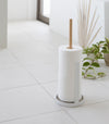 Toilet Paper Stocker holding toilet paper rolls on tile floor by Yamazaki Home.
