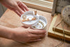 White Magnetic Wrap Holder holding oil and cooking paper by Yamazaki home.