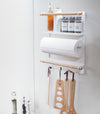 White Magnetic Organizer in kitchen holding kitchen utensils and cleaning items by Yamazaki Home.