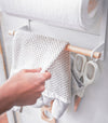 Close up of white Magnetic Organizer holding hand towel by Yamazaki Home.
