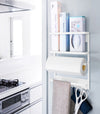 Front view of white Magnetic Organizer holding kitchen equipment by Yamazaki home.