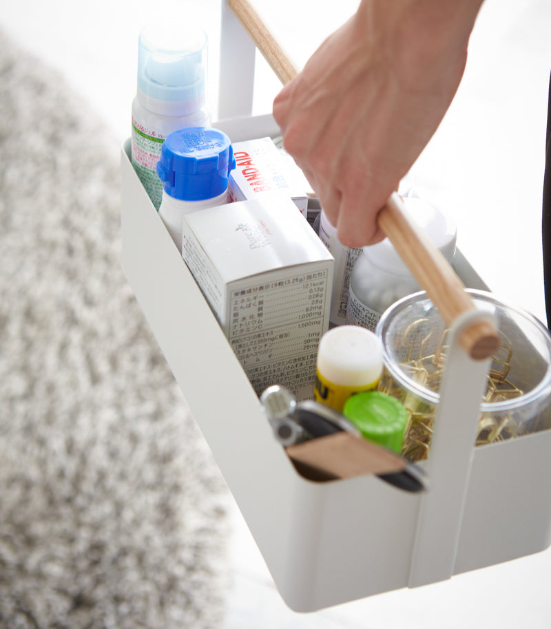 Aerial view of white Storage Caddy holding first-aid items by Yamazaki Home.