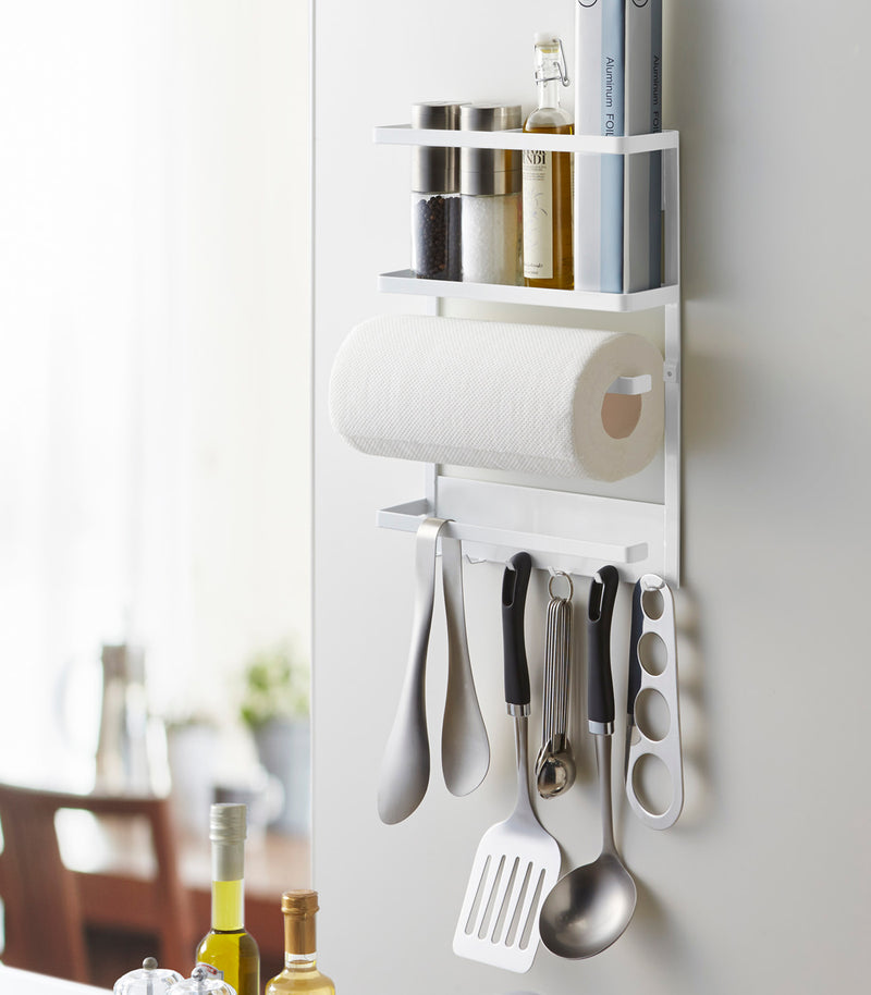 White Magnetic Organizer on kitchen fridge holding kitchen tools by Yamazaki home.